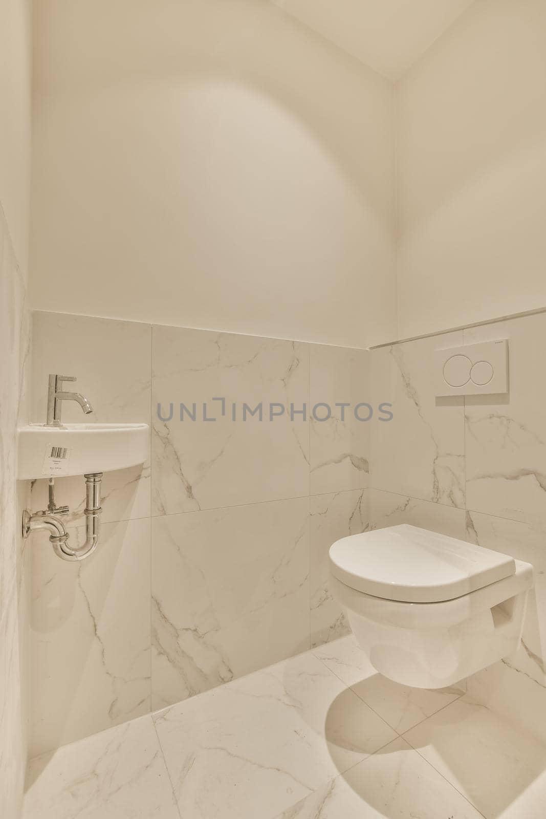 Sink base cabinet in white tiled bathroom with wall hung toilet