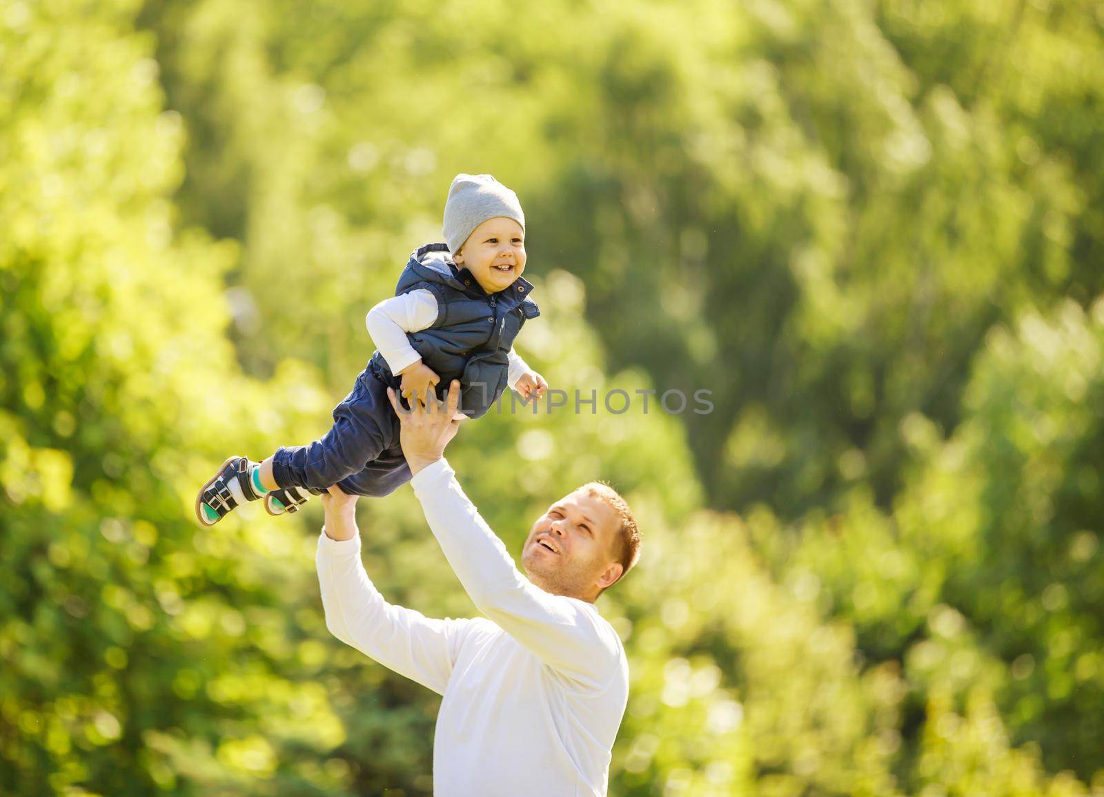 happy father and son on a walk on a Sunny day by SmartPhotoLab