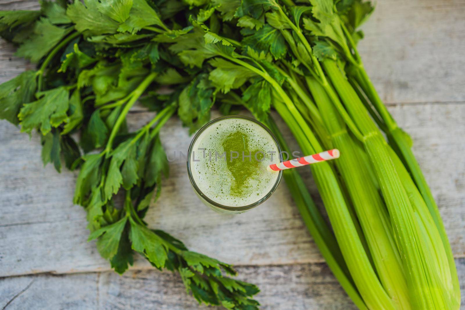 Celery Juice, Healthy Drink, bunch of celery on a wooden background.
