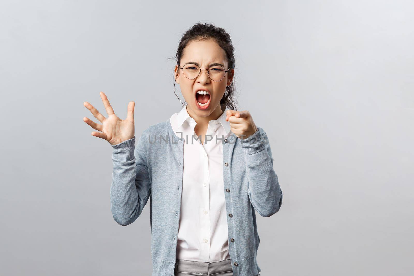 Emotions, family therapy and lifestyle concept. Its your fault. Angry asian woman blame her husband during argument, pointing finger with scold, accusing in cheating her, scream and arguing.