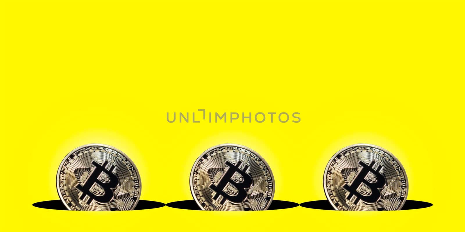 Virtual cryptocurrency concept, bitcoin gold coin on yellow background with copy space, bitcoin gold coin by isaiphoto