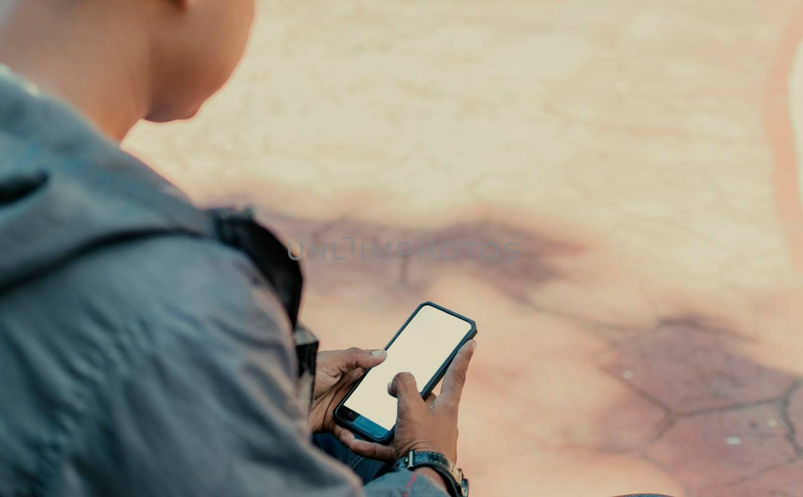 Close up of a man with cell phone in hand, close up shot of a person checking his cell phone, young guy with cell phone in hand with copy space