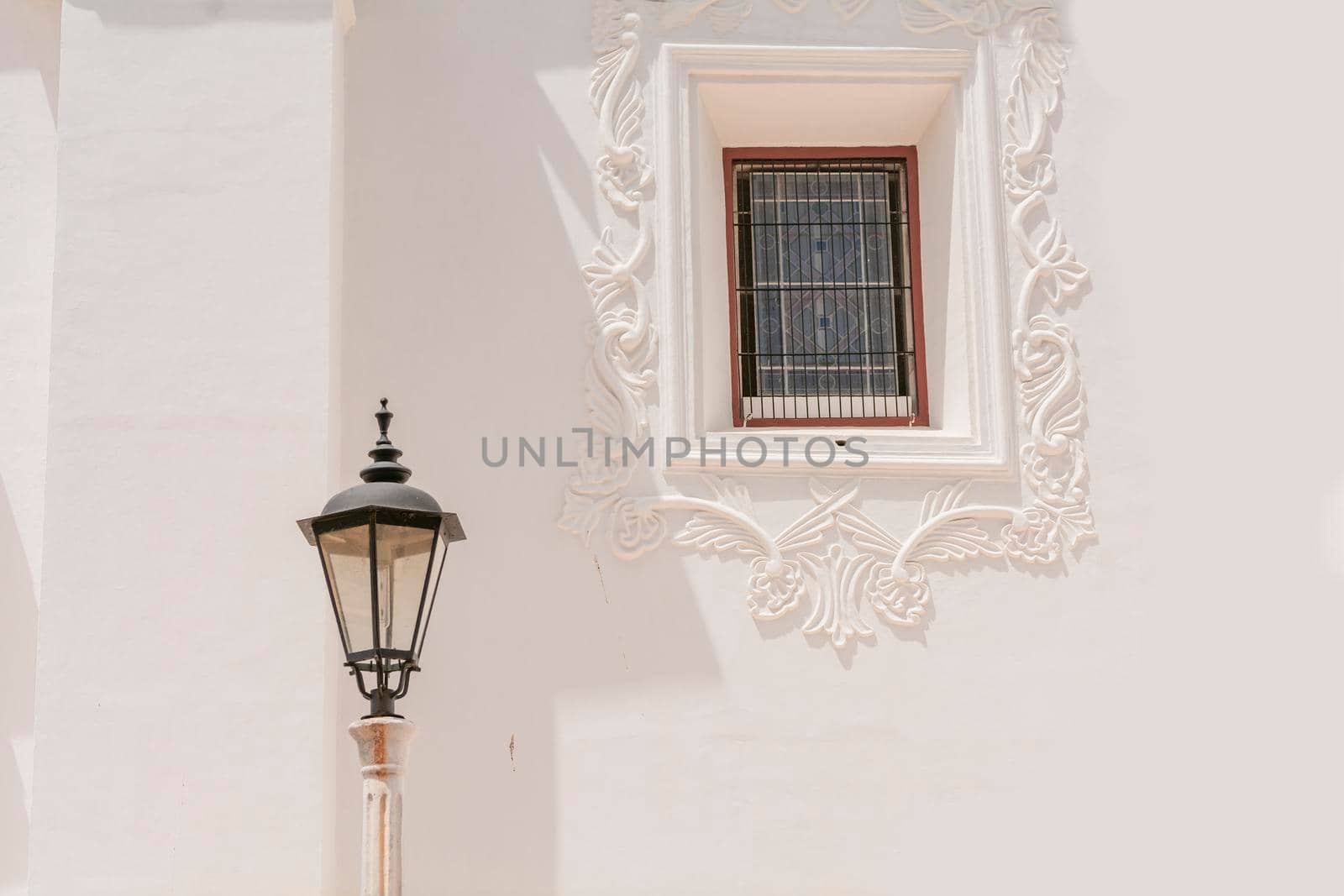 Lantern poles with copy space, an illuminated lantern pole next to a window, public lantern pole