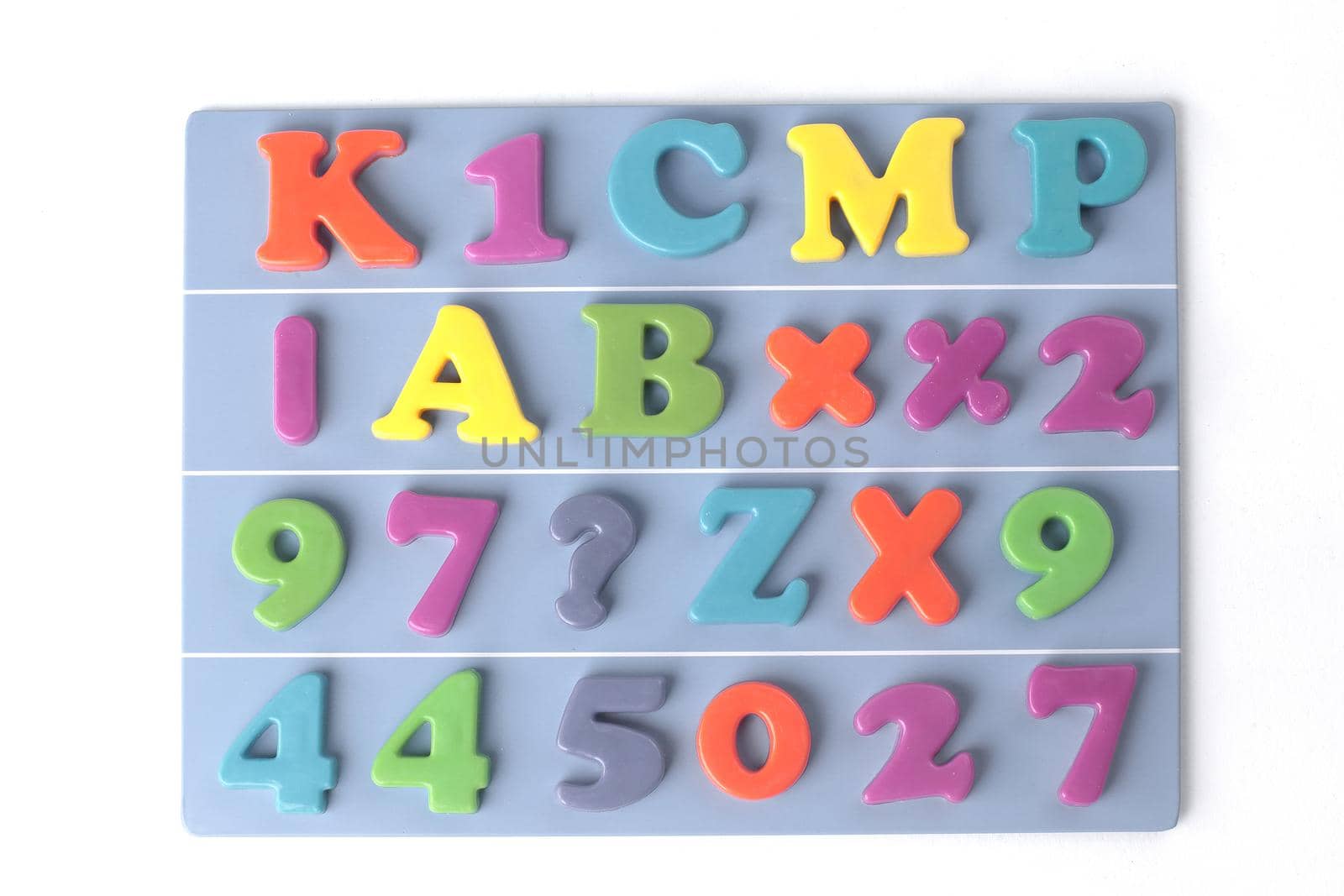 plastic magnetic colored english alphabet on blue background.
