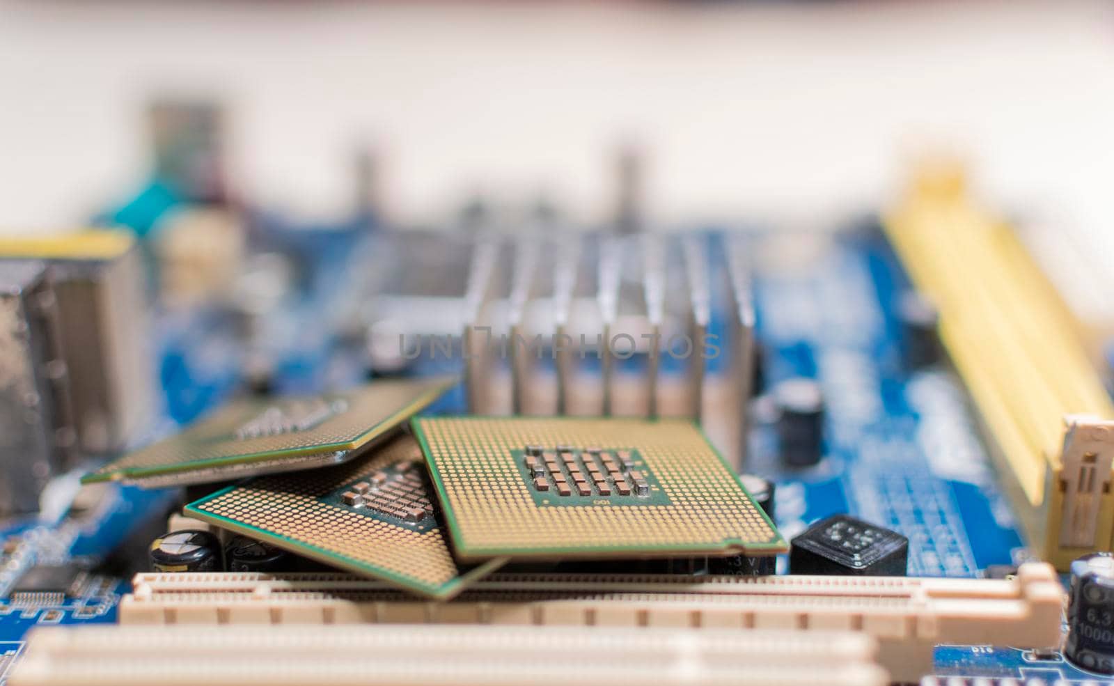 Close up of a motherboard, details of a computer motherboard, detail of a motherboard socket, three processors on a computer motherboard