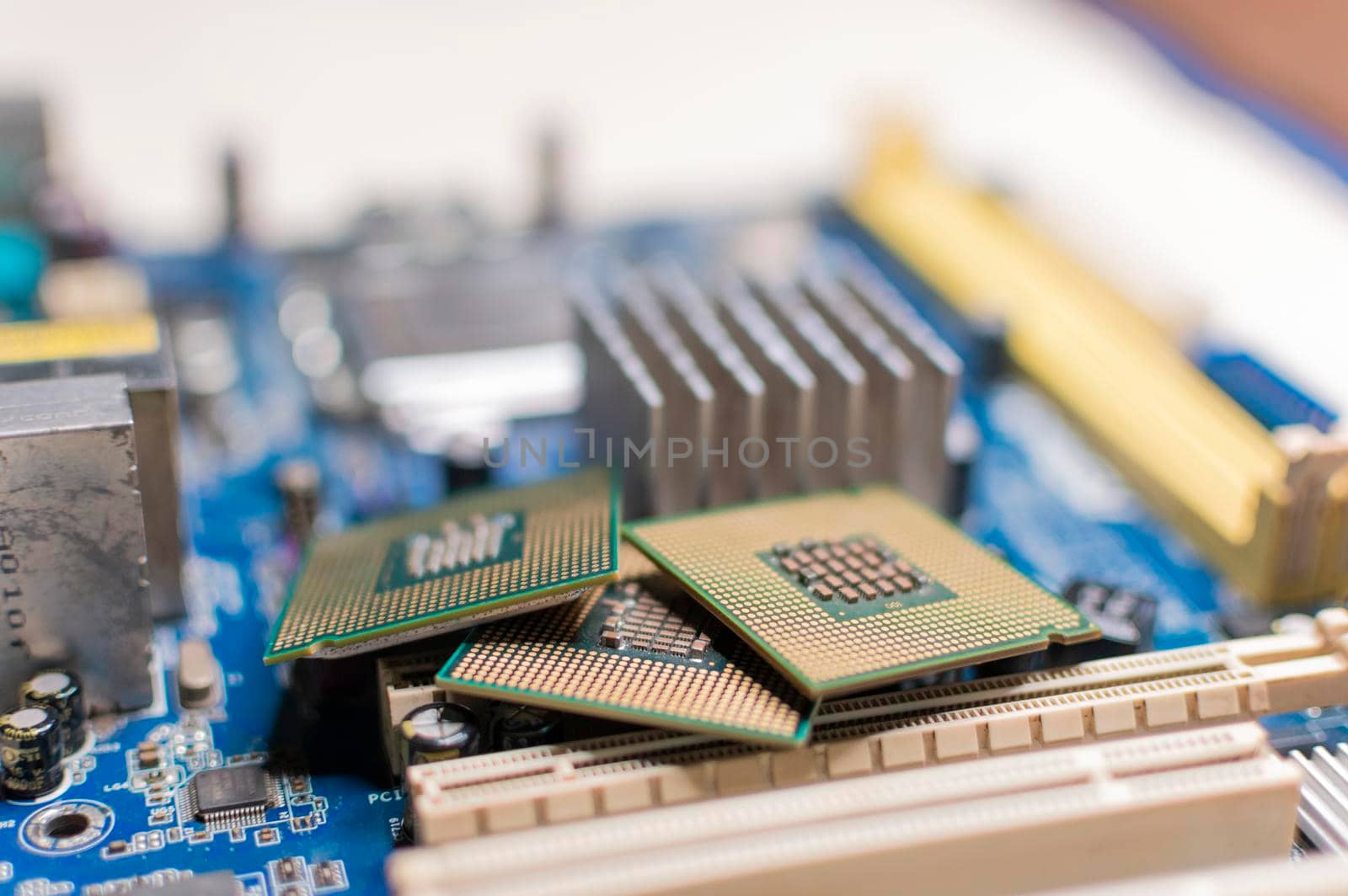 Close up of a motherboard, details of a computer motherboard, detail of a motherboard socket, three processors on a computer motherboard