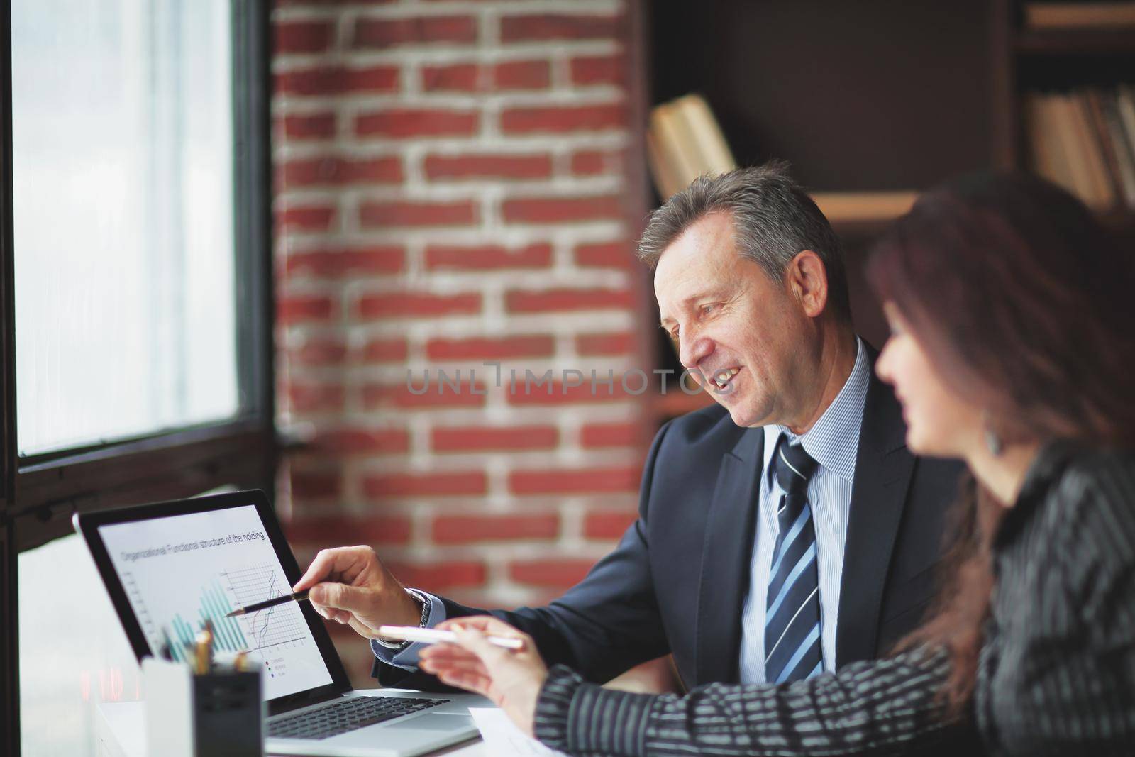 closeup.companions discussing financial profit using the laptop. by SmartPhotoLab