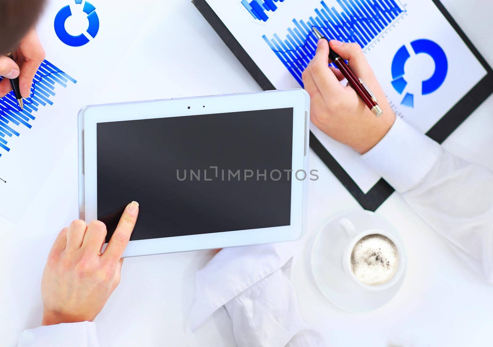 Close-up of business team hands over papers during discussion of a new project