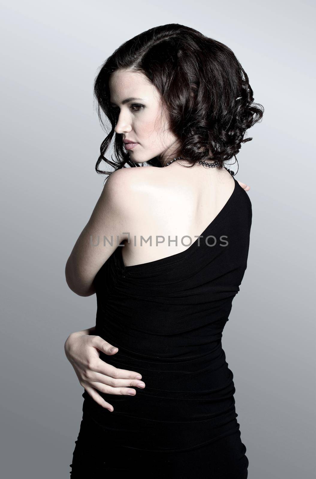 Fashion portrait of a young beautiful dark-haired woman