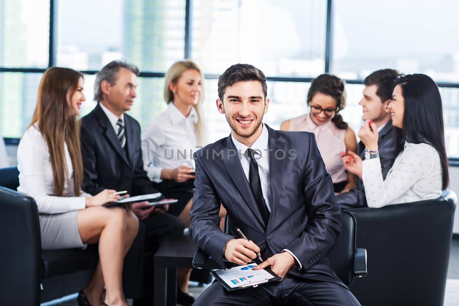 A group of businessmen discussing the policy of the company in the office.