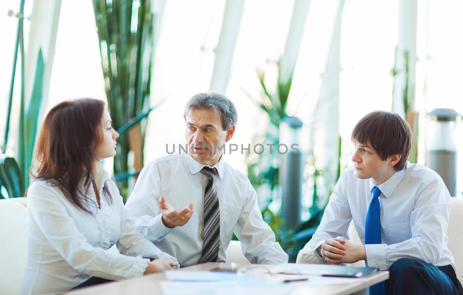 A serious meeting of business men at the office. Discussion and signing of the contract.