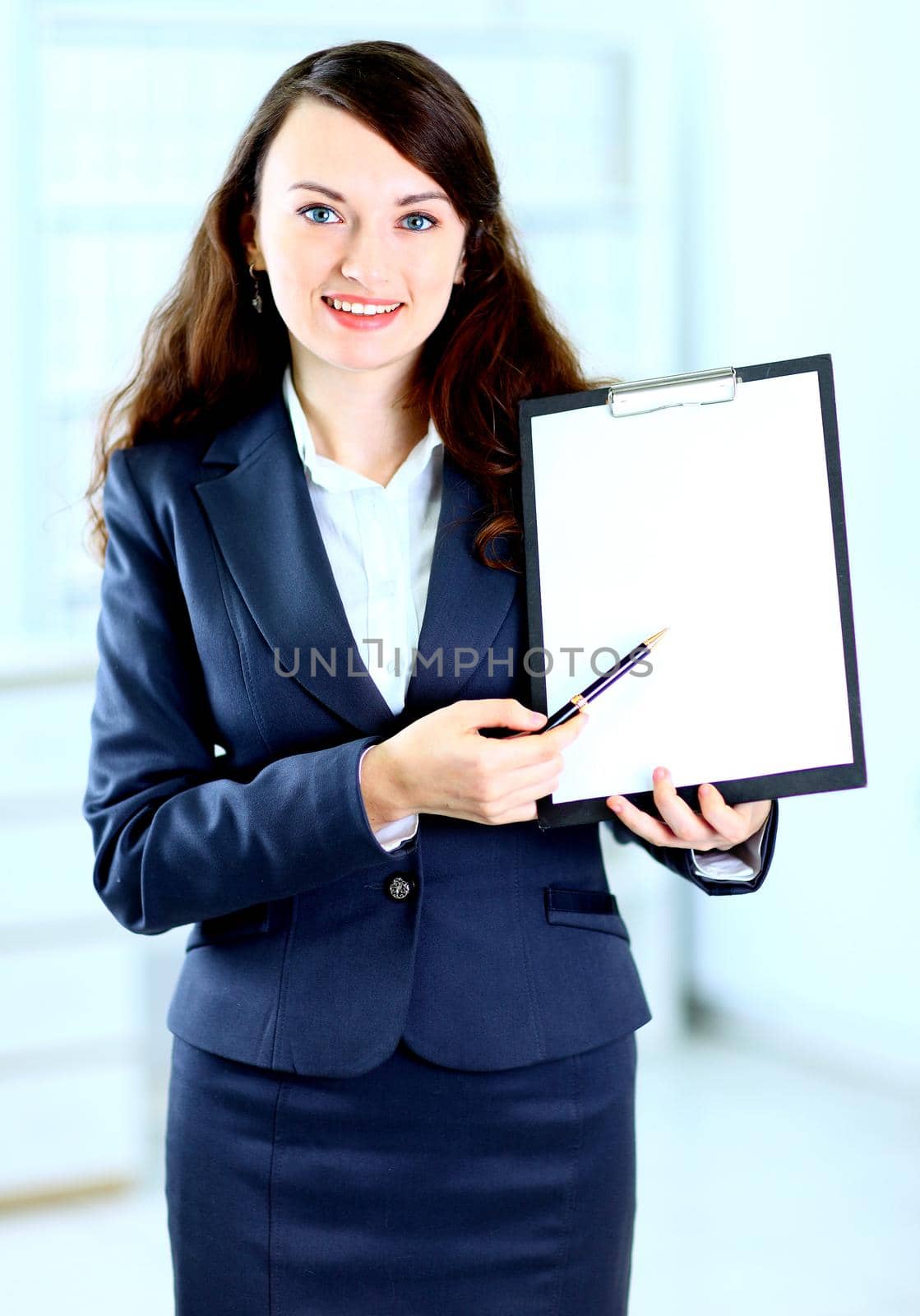 Portrait of a cute young business woman with the work plan smiling.