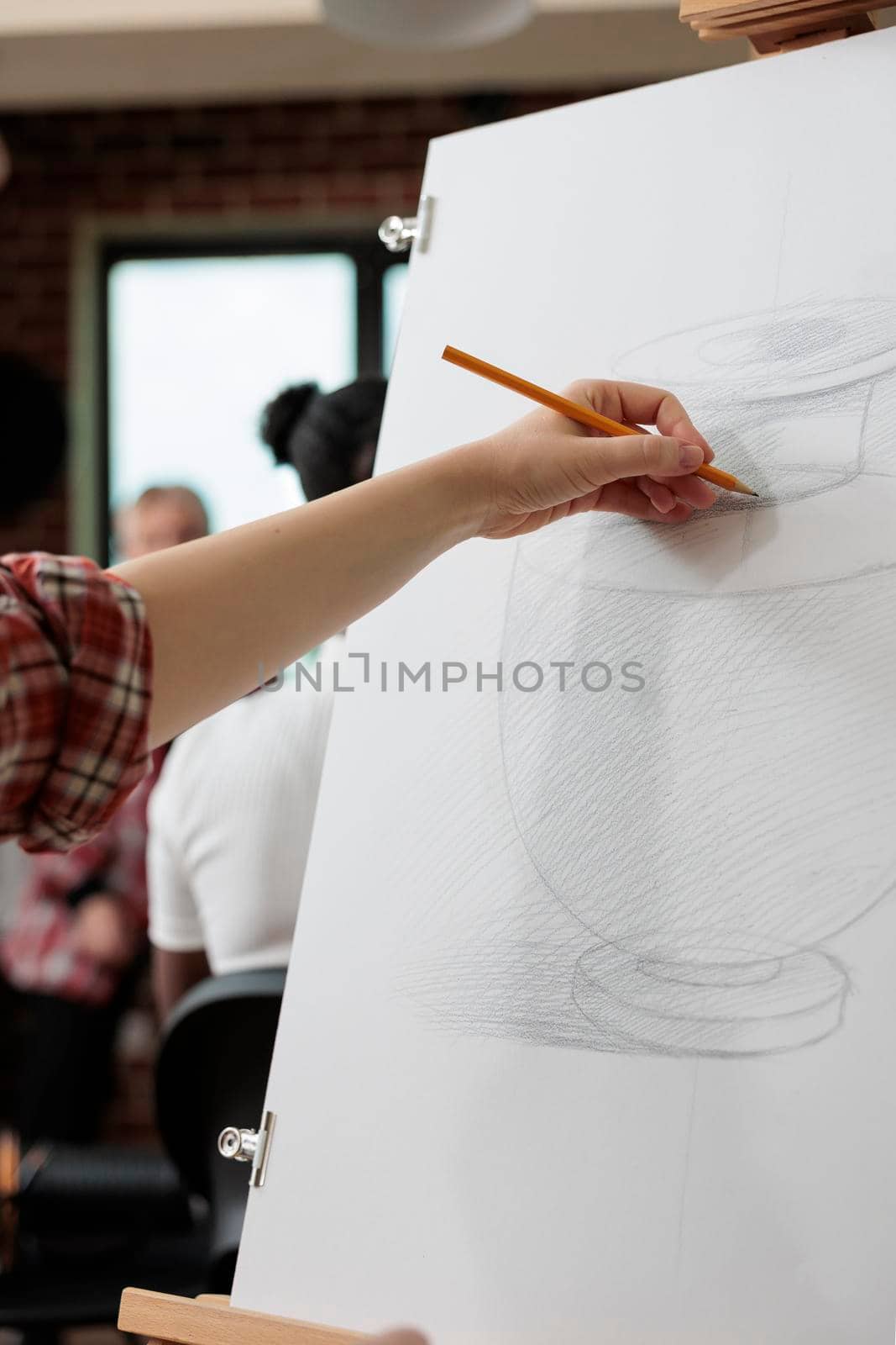 Artist man drawing vase sketch on white canvas working at graphic illustration using sketching technique during art school. Student painter attending creativity lesson for personal growth