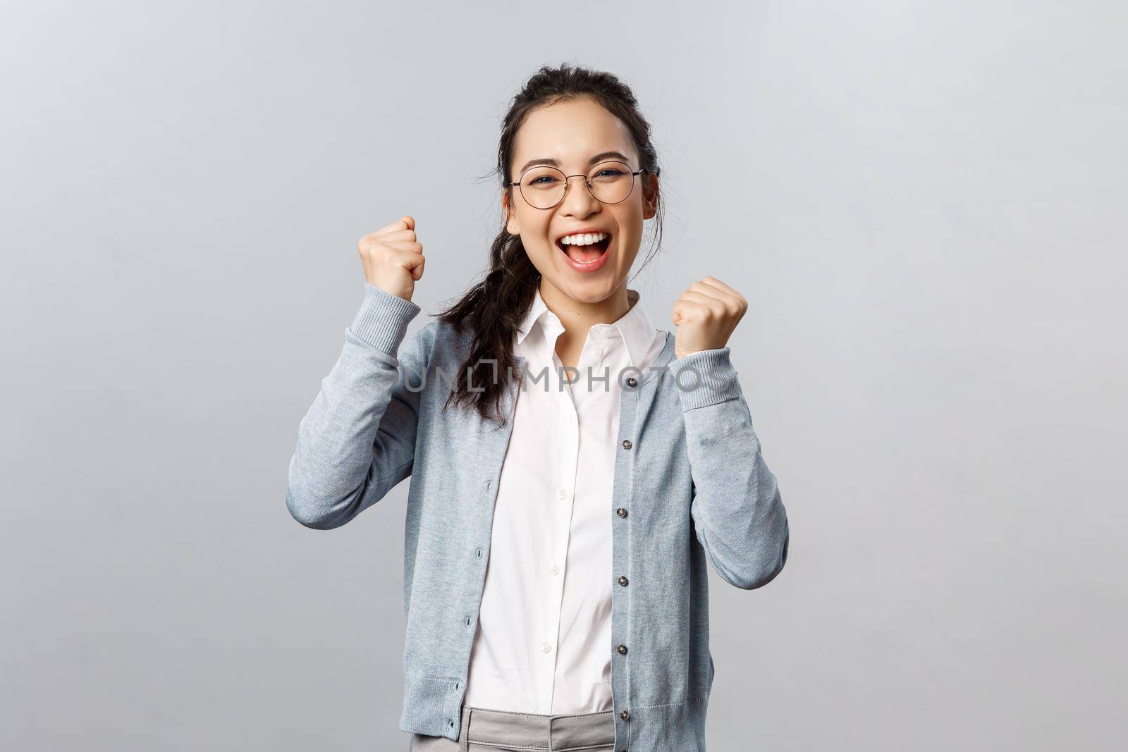 Super cool news, good for you. Optimistic, supportive asian girl encourage friend, watching sports game and rooting for team, chanting and smiling, triumphing from success, celebrate victory by Benzoix