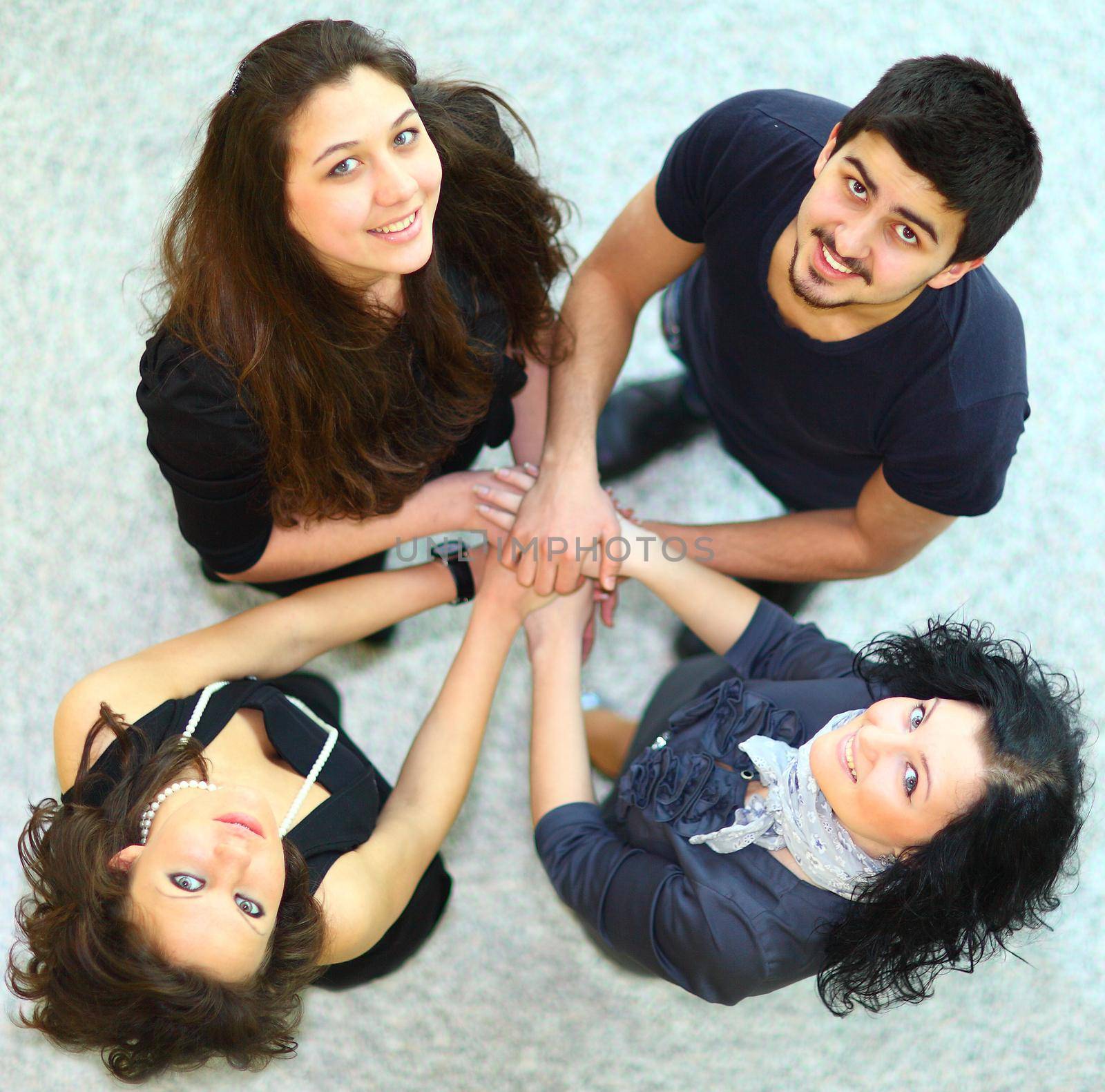 Group of people with hands together showing teamwork