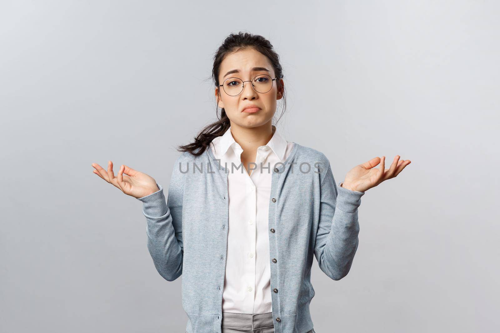Well, we have nothing to do about it, cant deal problem. Portrait of indecisive or desperate asian woman shrugging and raise hands sideways perplexed, dont know cant tell, being clueless by Benzoix