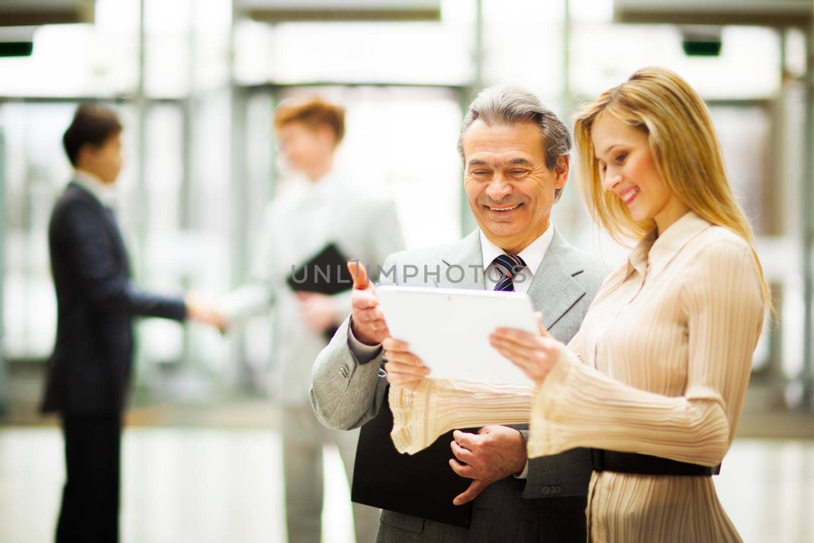 Business people using a digital tablet