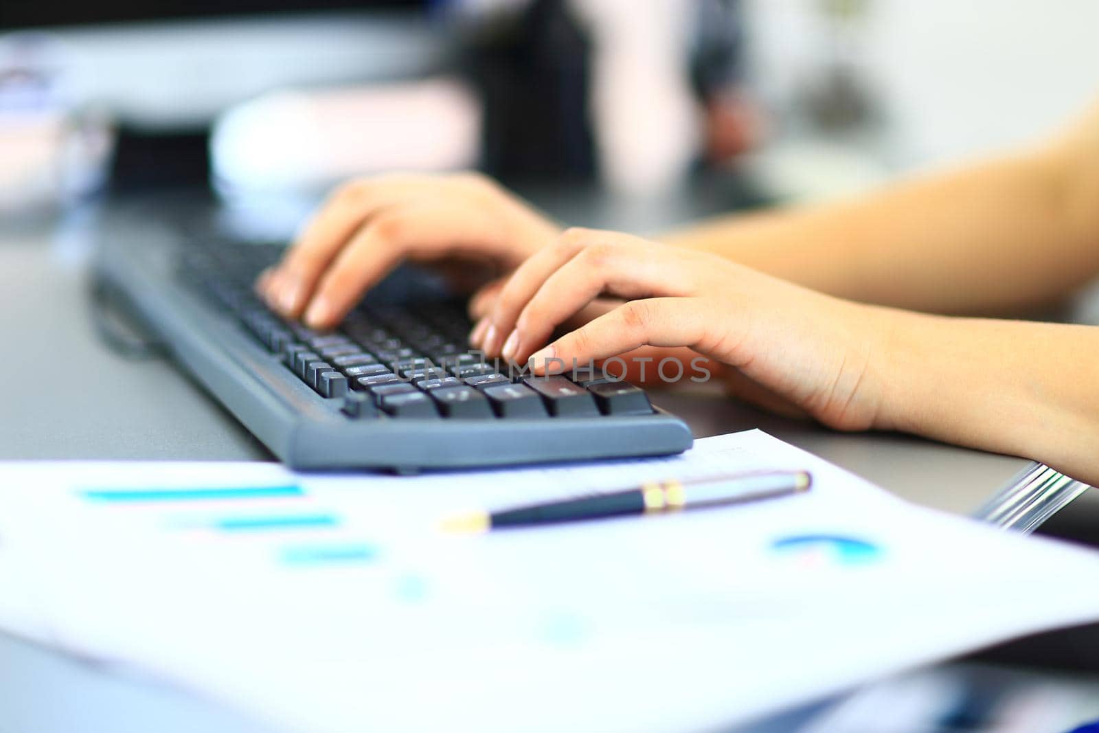 Close-up shot of a female learner typing on the keyboard