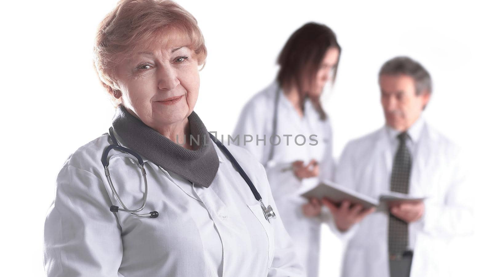 adult female doctor therapist on blurred background of colleagues.