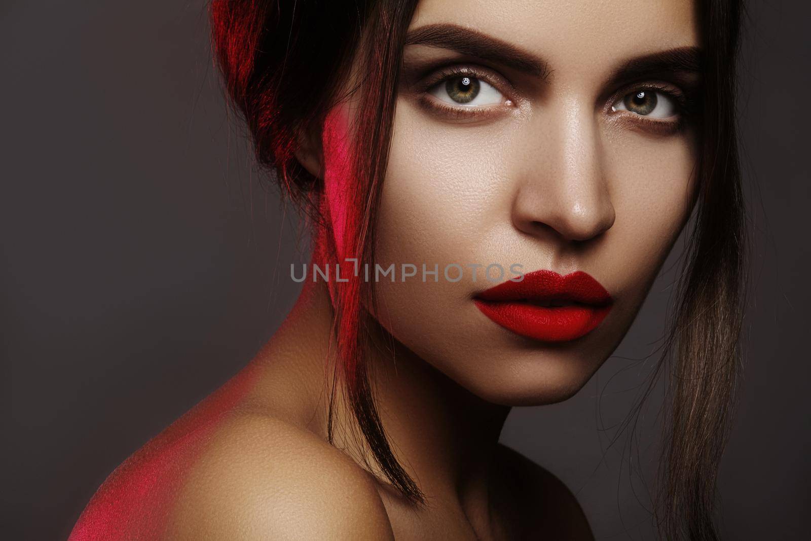Beautiful model with fashion make-up. Portrait sexy woman with glamour red lips makeup, strong eyeshadows, hairstyle by MarinaFrost