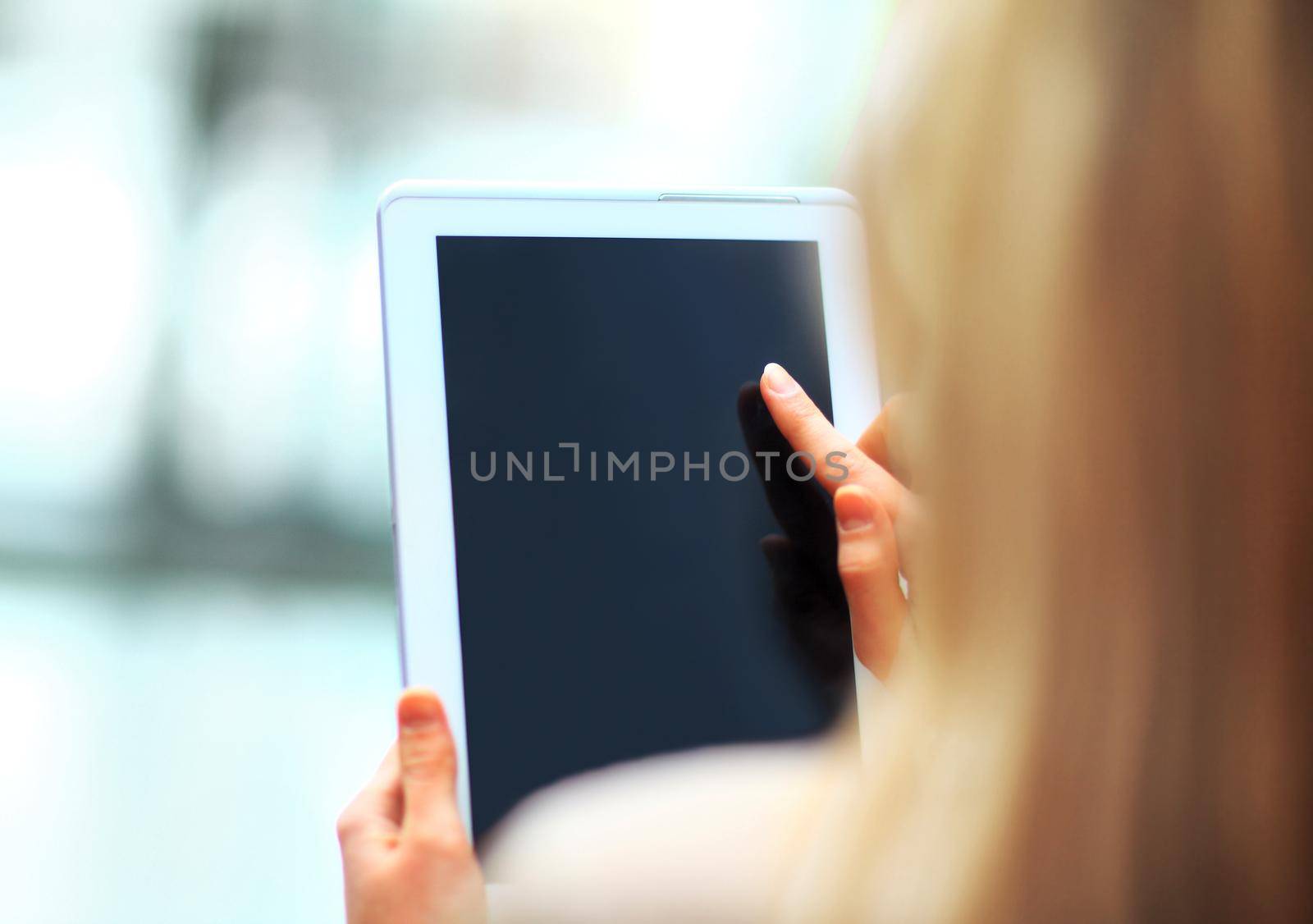 Close-up of businesswoman working with touchpad in office