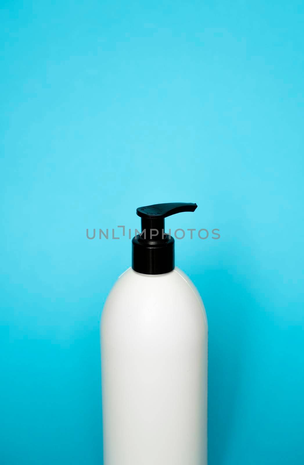 Plastic shampoo bottle on a blue background. Mock up template for design