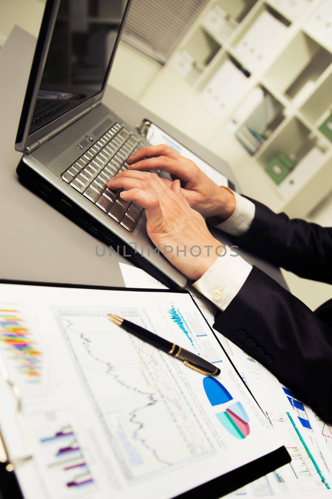 Person Typing on a modern laptop in an office