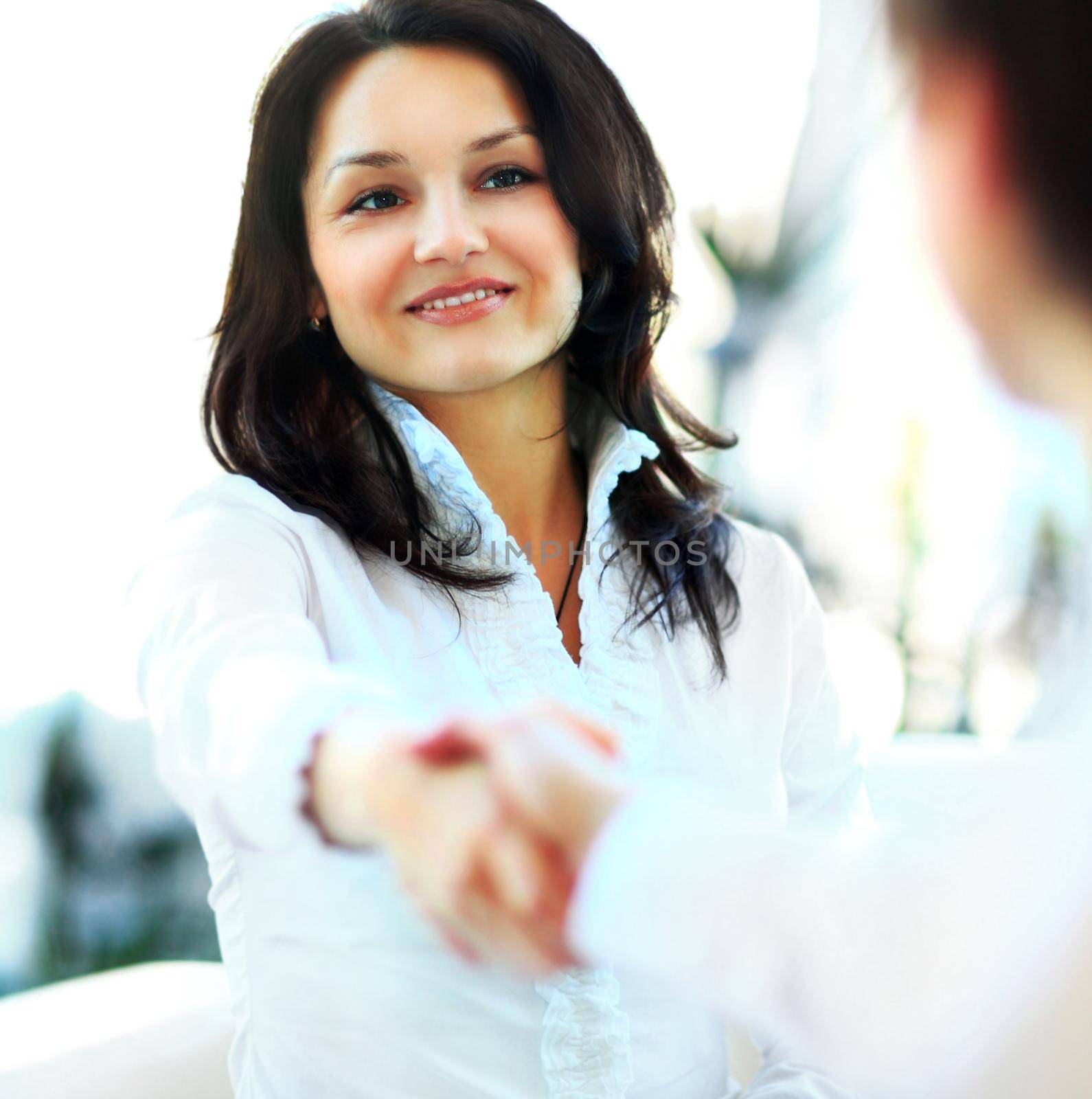 Business woman gives a handshake by SmartPhotoLab