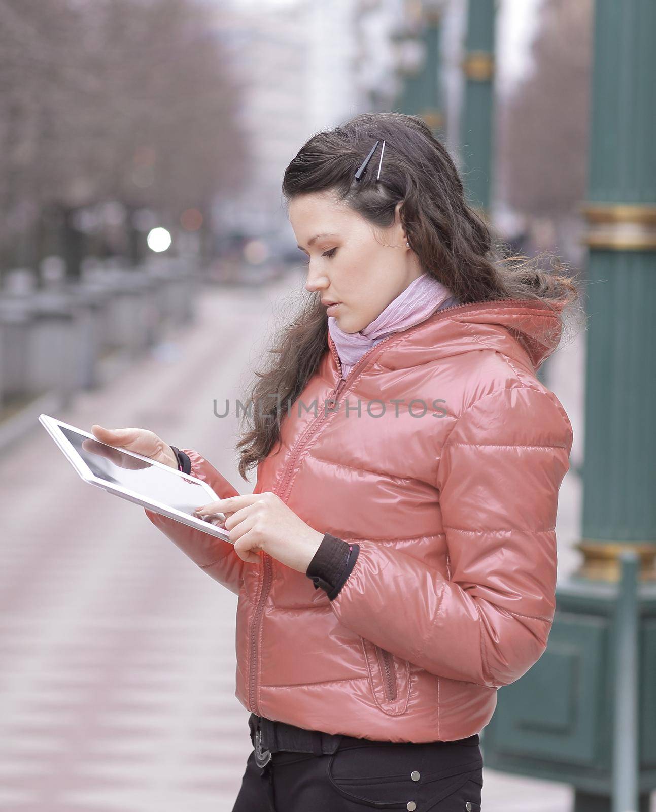 smiling woman looking at digital tablet screen.