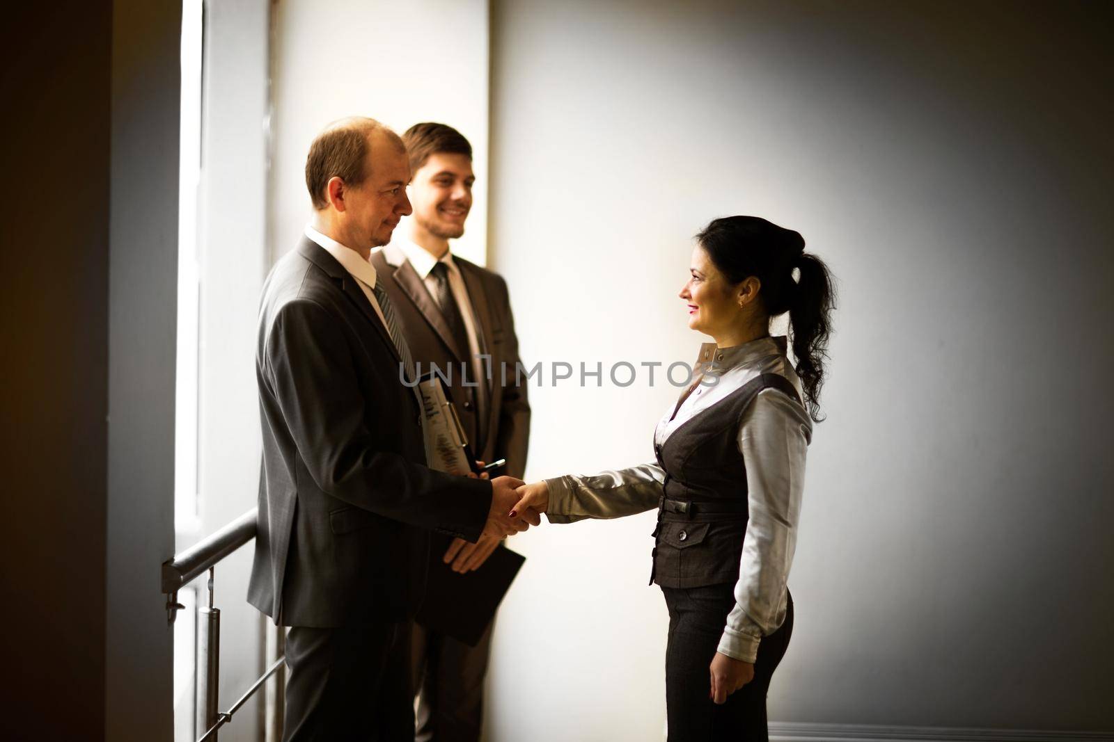 cheerful business men shaking hands
