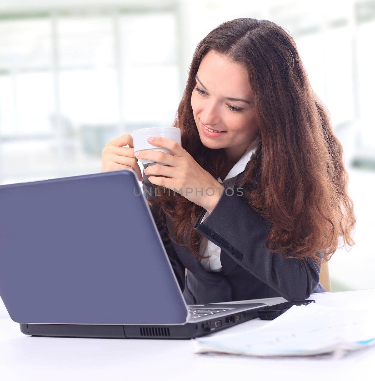 Thoughtful business woman in an office smiling by SmartPhotoLab