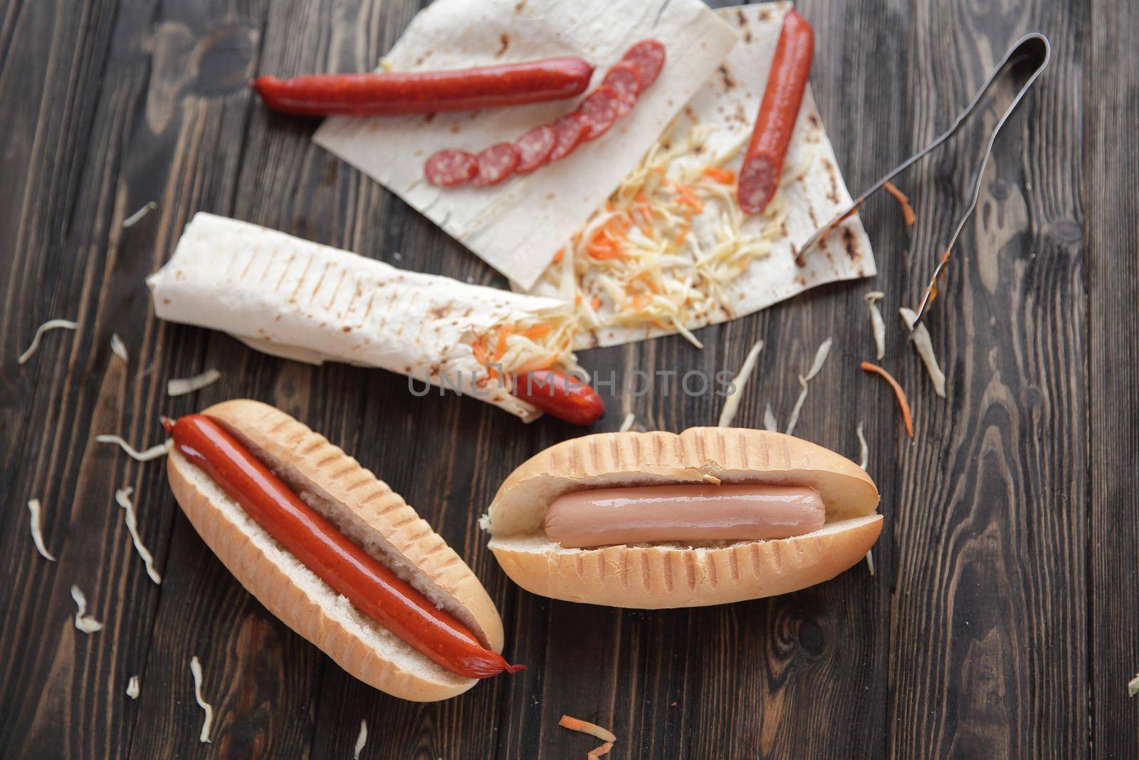 preparation of hot dogs with sausage.photo on a wooden background.