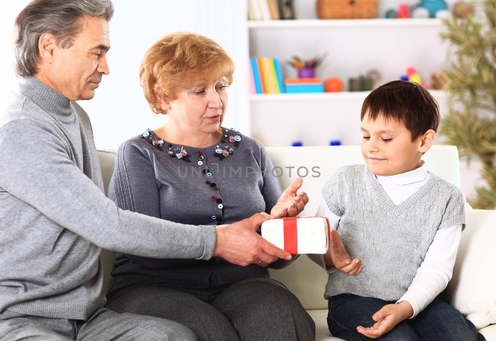 Family in sofa giving presents for Christmas