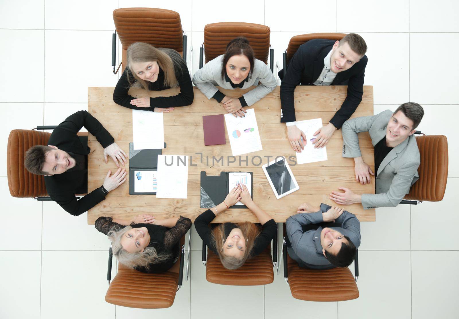 top view. young business team sitting at a table and looking at the camera by asdf