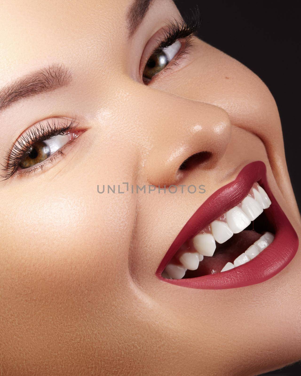 Fashion Woman Face With Perfect Smile. Close-up Of Beautiful Girl Face With Bright Make-up. Female Model With Smooth Skin, Extra Long Eyelashes, Red Lips and Healthy White Teeth