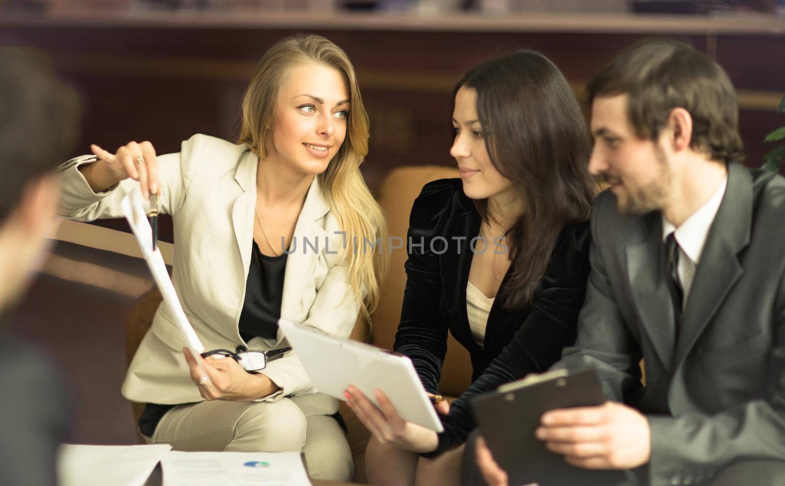 Image of business people listening and talking to their colleague at meeting