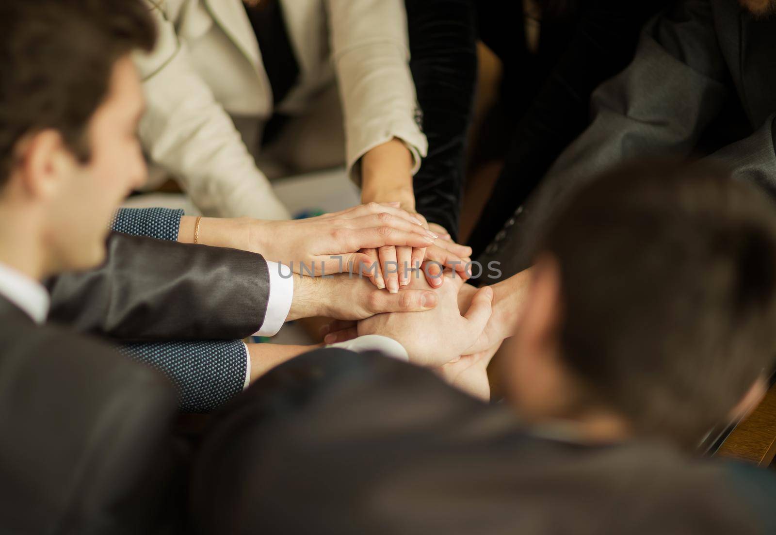 The conference of entrepreneurs. The folding of hands together and raise them up.