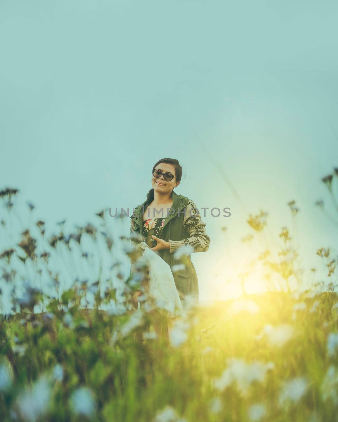 Portrait of a girl in glasses in the field, cute Latin girl smiling in the field at sunset by isaiphoto