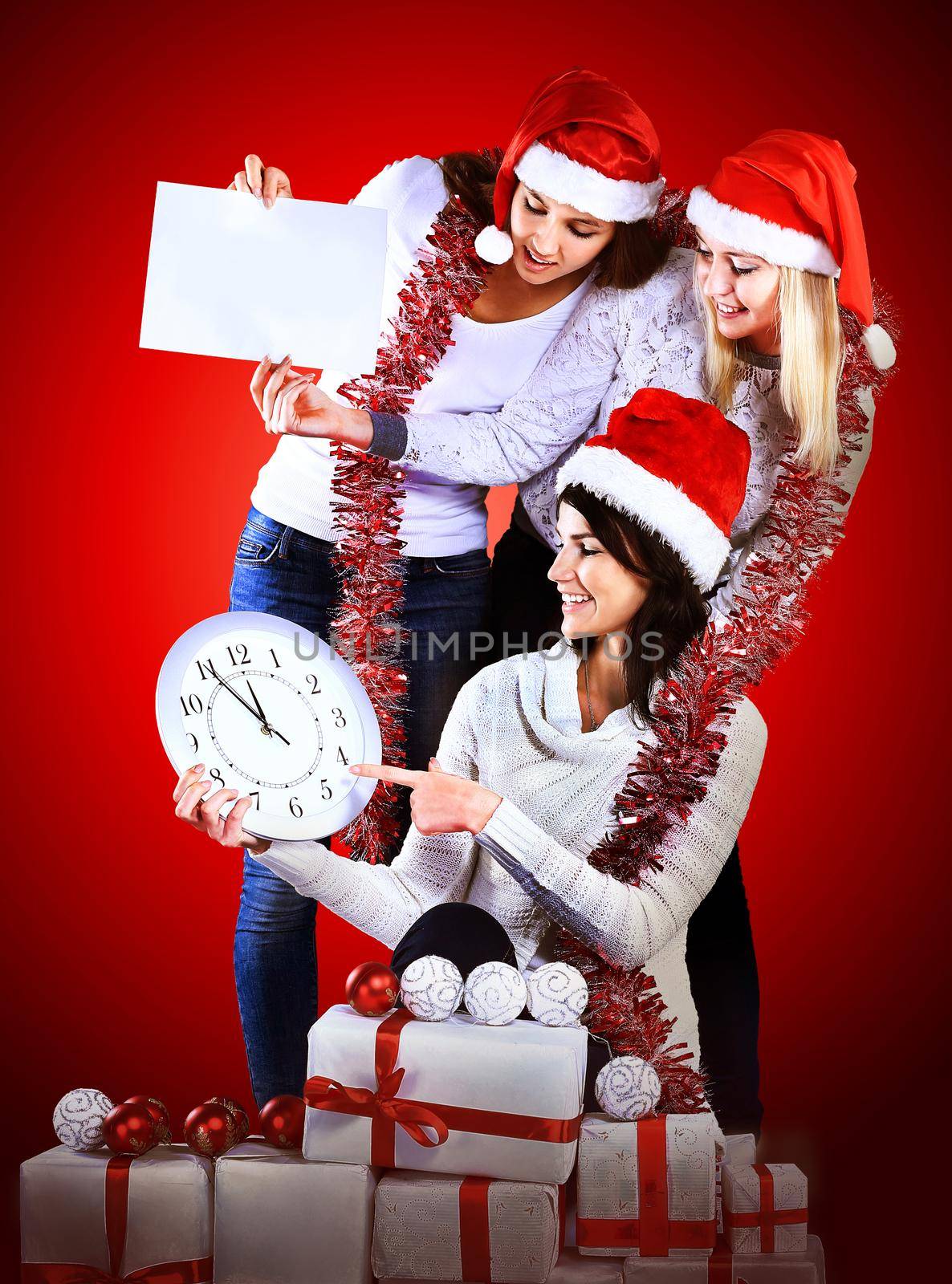 Girls with a new year gift on a dark background by SmartPhotoLab