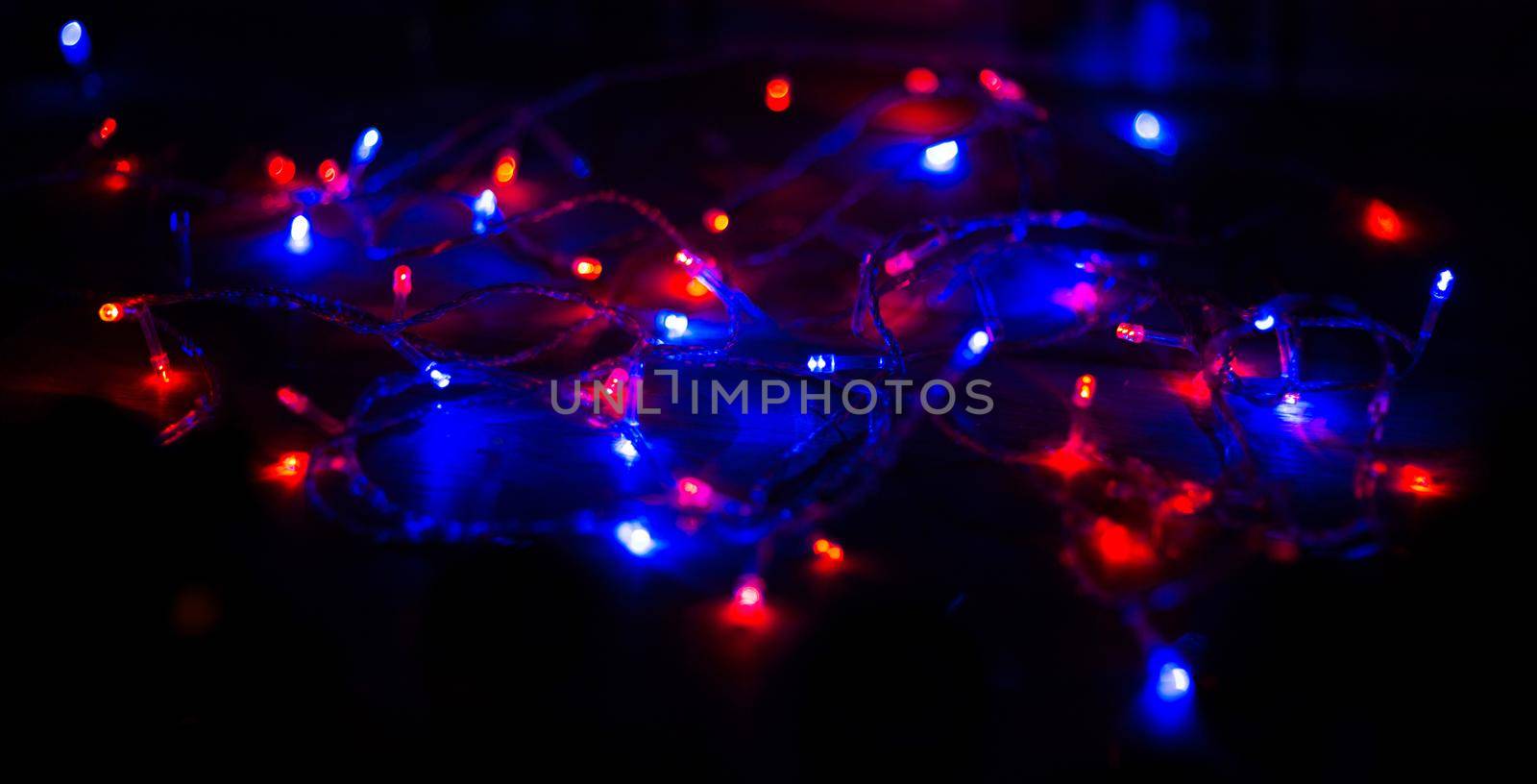 Christmas lights on dark background with copy space. Decorative garland