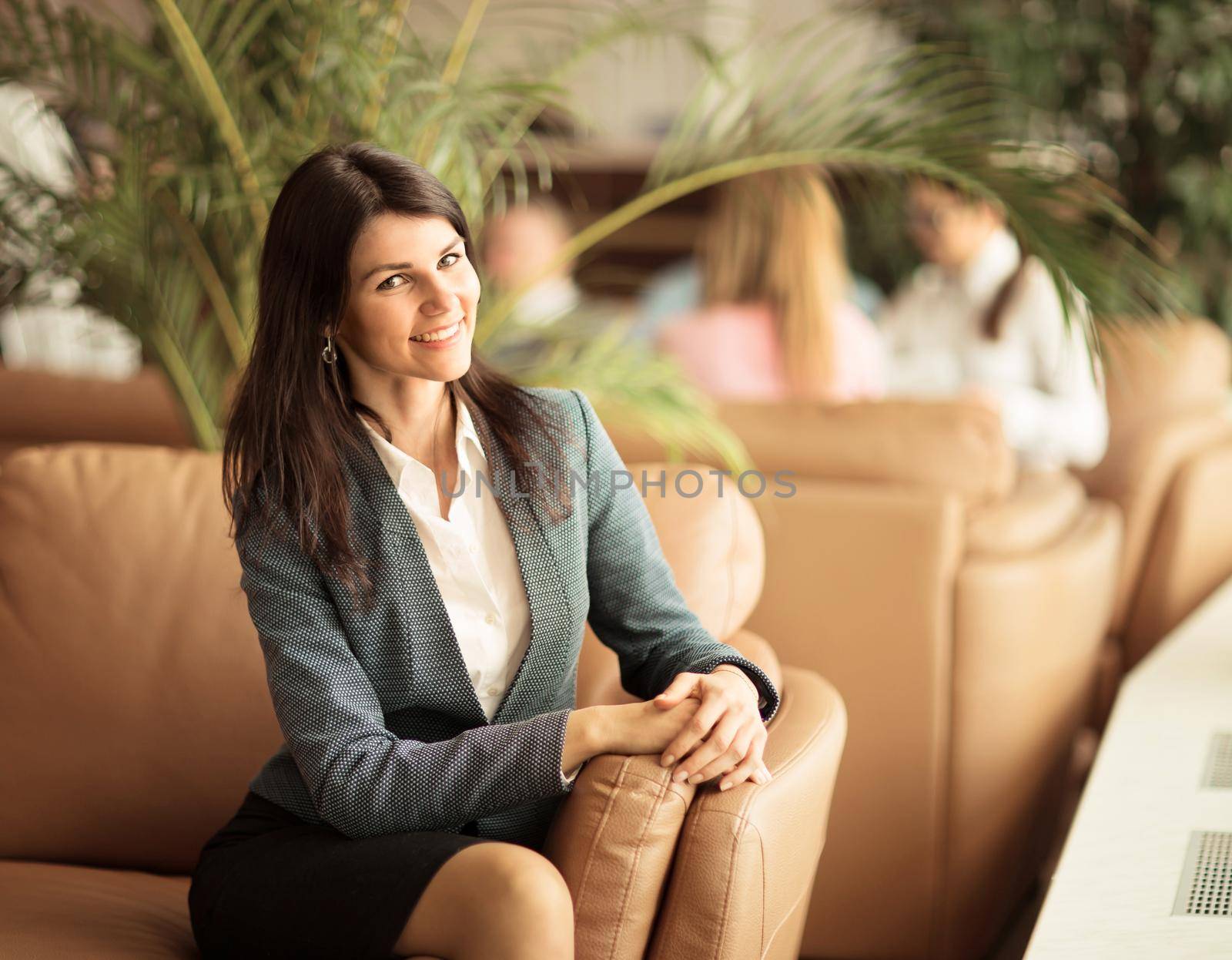 Beautiful business woman. Resting on the couch after a business lunch.