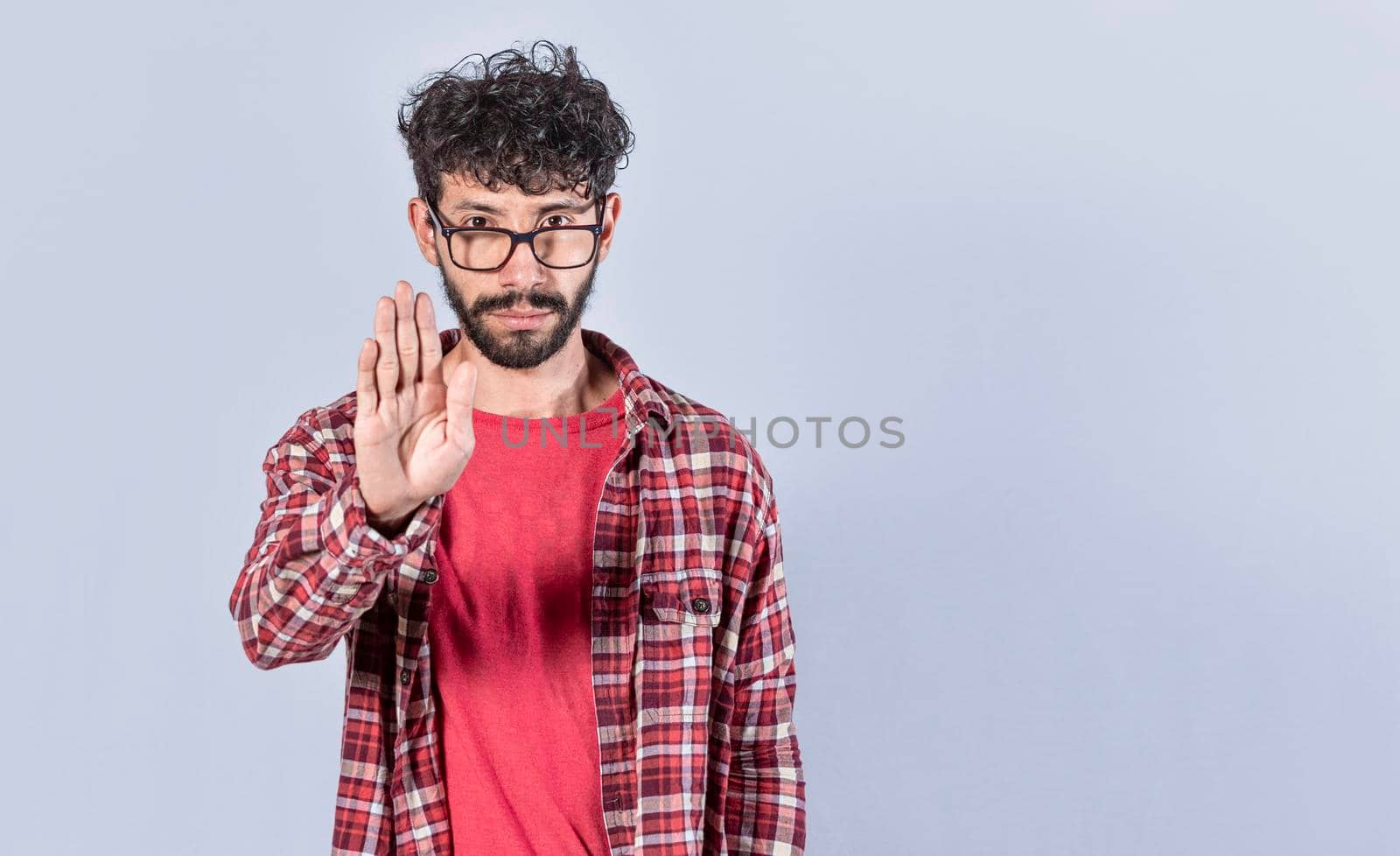 Serious young man stop sign with palm, caucasian man stop sign with hand, stop concept with hand