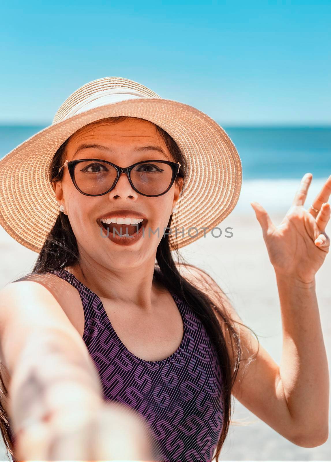 Pretty girl taking a selfie on the beach, happy pretty girl taking a selfie on the beach, vacation concept