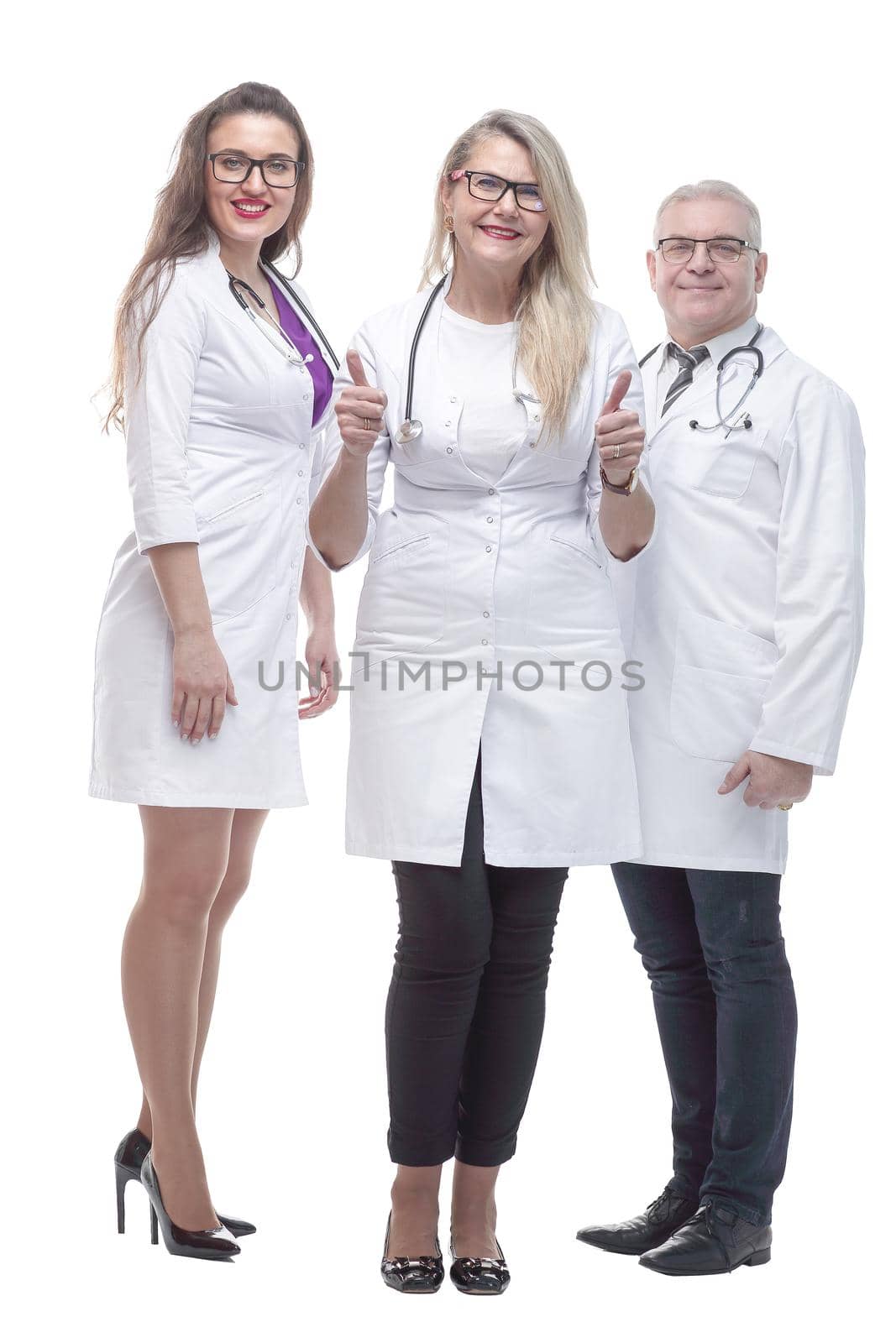 in full growth. a friendly female doctor standing in front of her colleagues. isolated on a white background