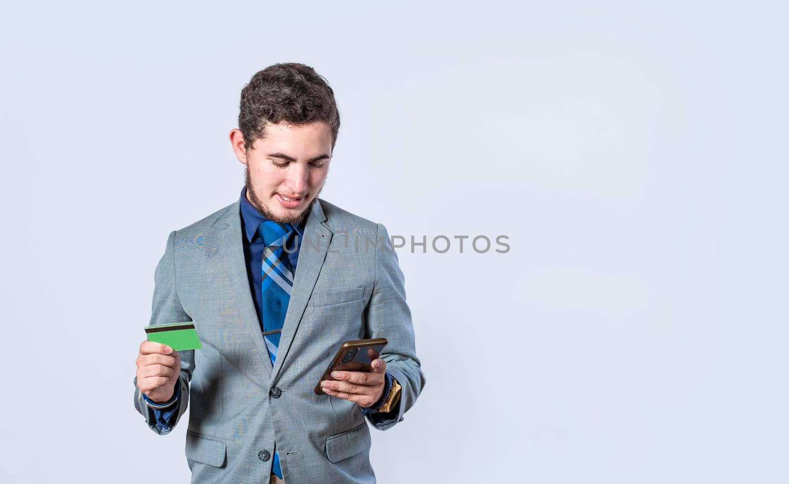 man with credit card and cell phone in hand isolated, cheerful businessman with cell phone and bank card isolated, bank payment concept