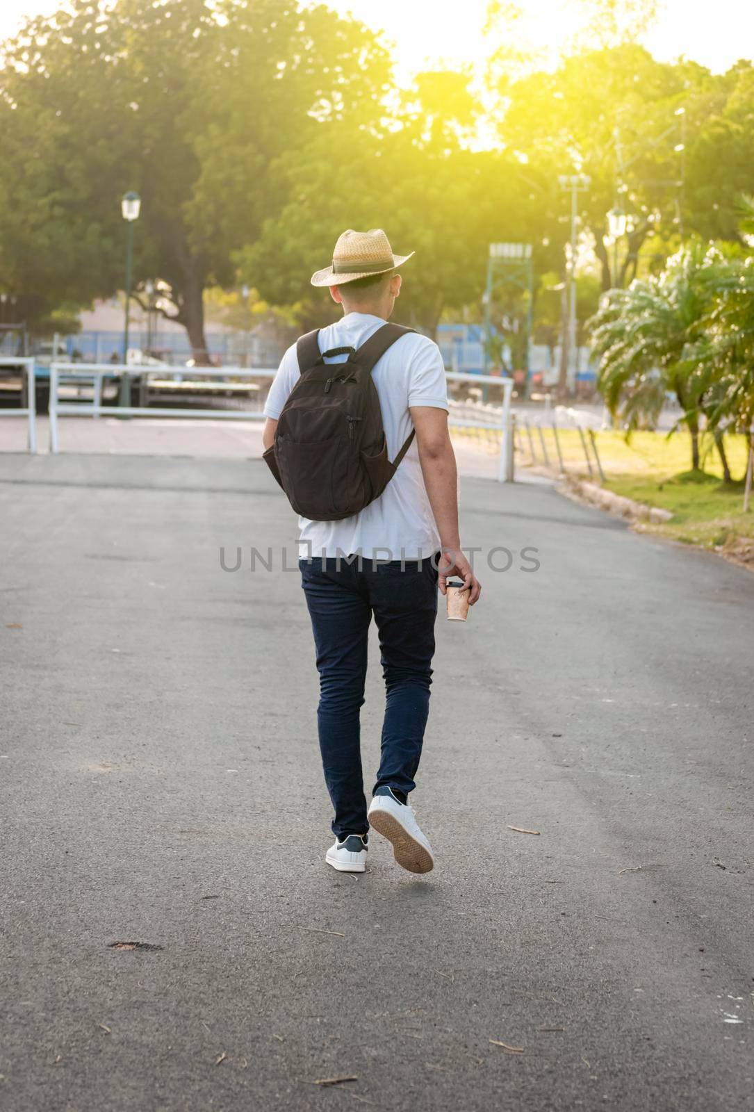Hipster guy walking on the street, traveler guy walking in the city, attractive man in hat walking on the street by isaiphoto