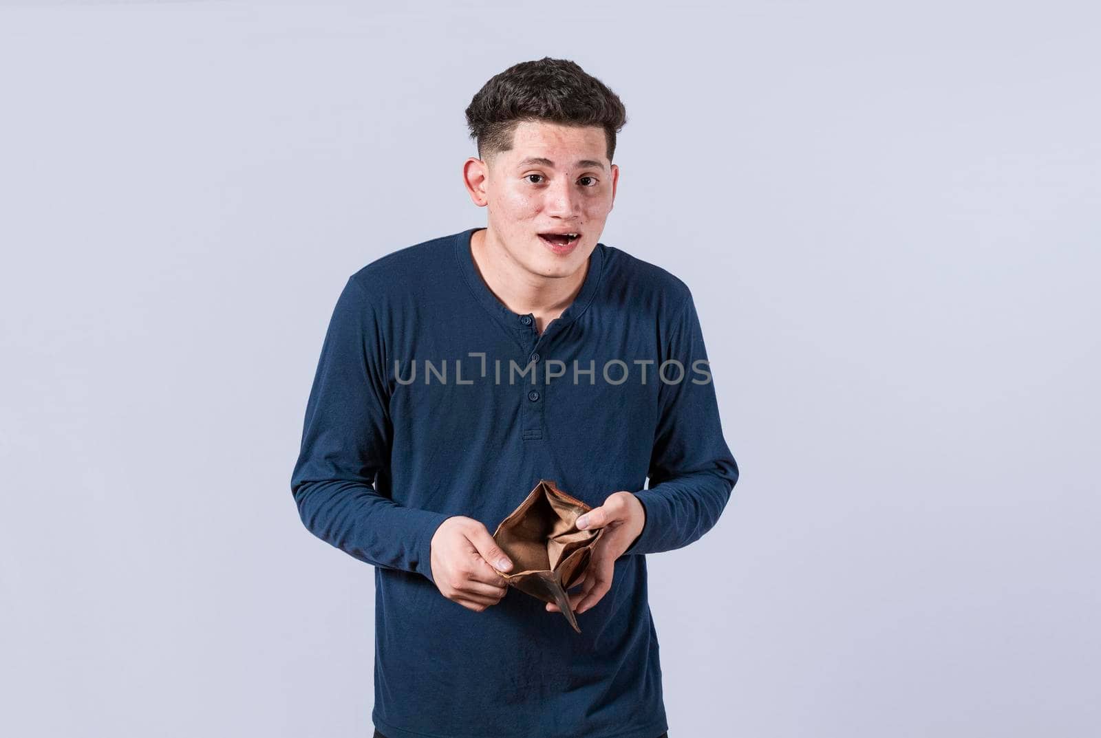 unhappy and surprised man looking in an empty wallet, man seeing his empty wallet, young man with wallet without money