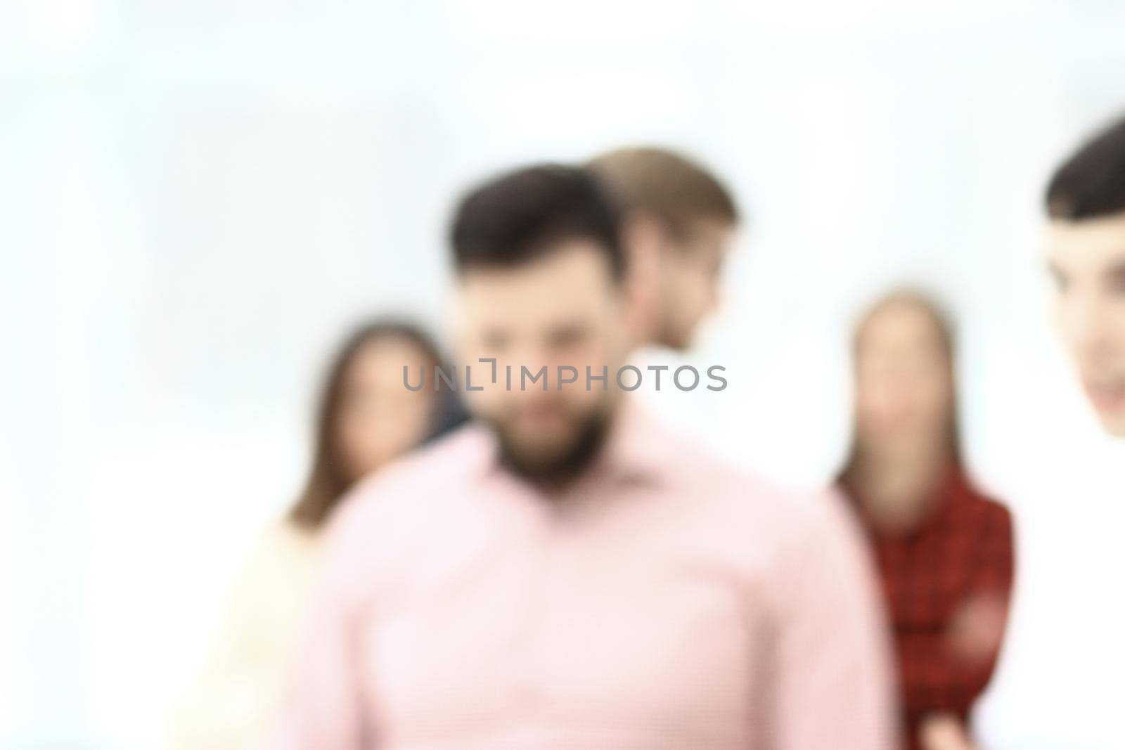 background image of a business team talking in the office hall in blur