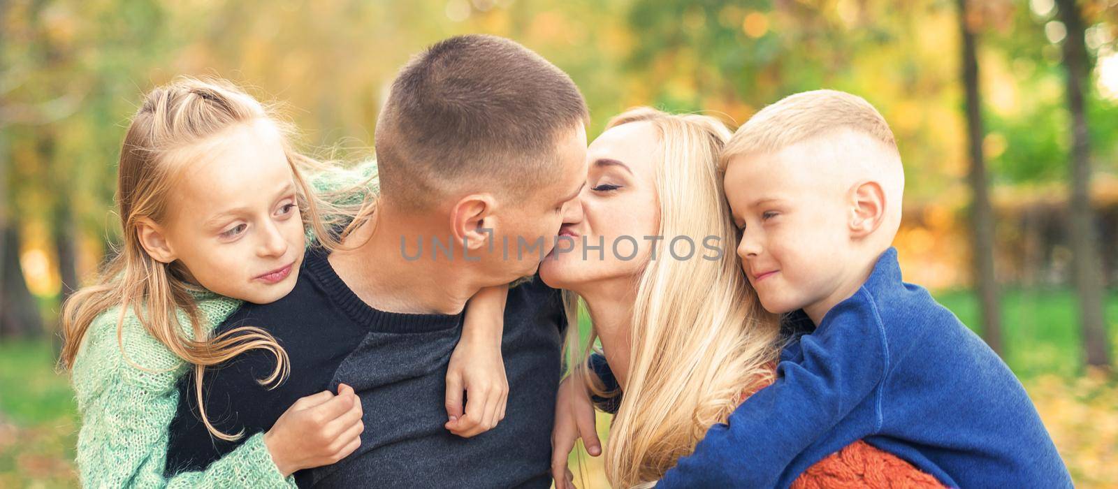 Portrait of young family in autumn park by okskukuruza