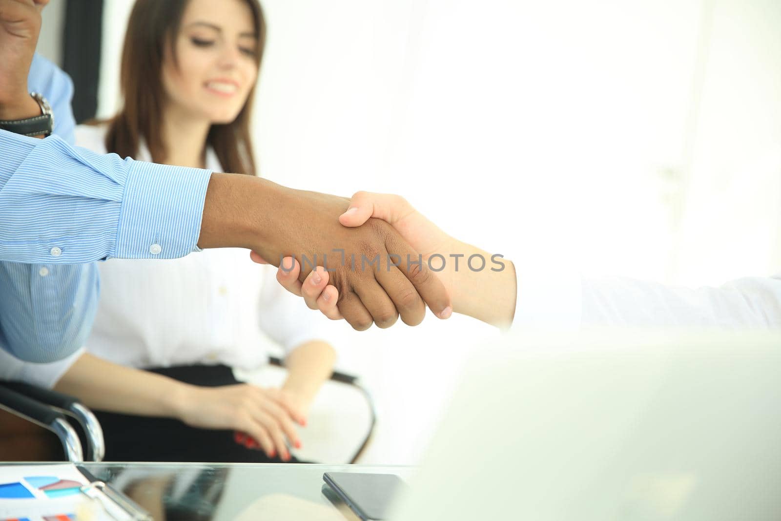 closeup.the financial partners shaking hands over a Desk.the concept of profitable partnerships